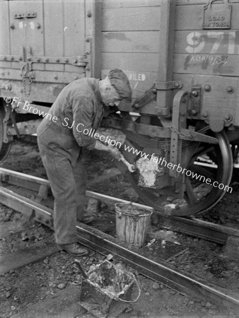 OILMAN AT WORK ON WHEEL